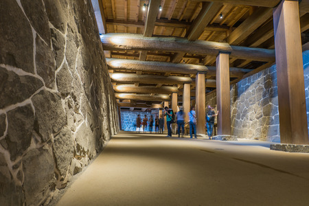KUMAMOTO, JAPAN - SEPTEMBER 27, 2014: Tourists walking under Kumamoto castle in Kumamoto, Japanのeditorial素材