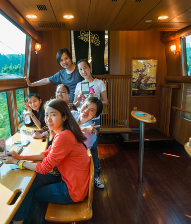 Yufuin, Japan - September 28, 2014: Group of friends in the express train Yufuin no Mori. Yufuin no Mori (The Forest of Yufuin) are limited express train services operated by Kyushu Railway Company (JR Kyushu) which run from Hakata via Yufuin to Oita and のeditorial素材