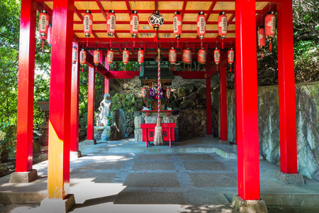 Beppu, Japan - September 28, 2014: Small shrine in Umi Jigoku or Sea hell in Beppu, Oita, Japan is one of the most beautiful hells, the "sea hell" features a pond of boiling, blue water. In its spacious gardens, there are a few secondary, orange colored hのeditorial素材