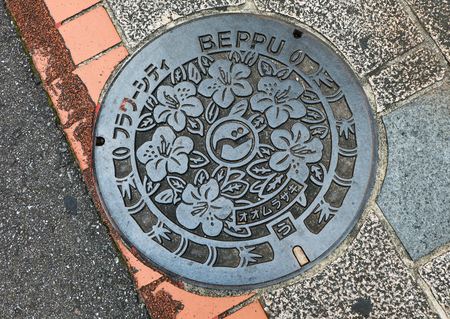 Beppu, Japan - September 28, 2014: Manhole cover in Beppu, Japan. With bamboo and sakura flower on a manholeのeditorial素材