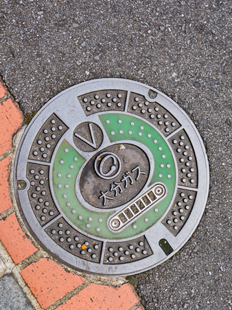Beppu, Japan - September 28, 2014: Manhole cover in Beppu, Japan. With symbol and number on a manholeのeditorial素材