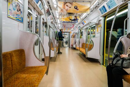 Tokyo, Japan - April 30, 2016: The interior of a subway train carriage in Tokyo, Japan with passengers.のeditorial素材