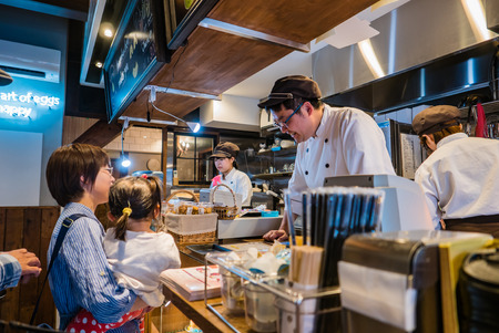 Kawagoe, Japan - May 1, 2016: Tourists in bakery shop in Kawagoe town. Kawagoe is a city in Saitama Prefecture, in the central Kanto region of Japan. The city is known locally as "Little Edo" after the old name for Tokyo, due to its many historic buildingのeditorial素材