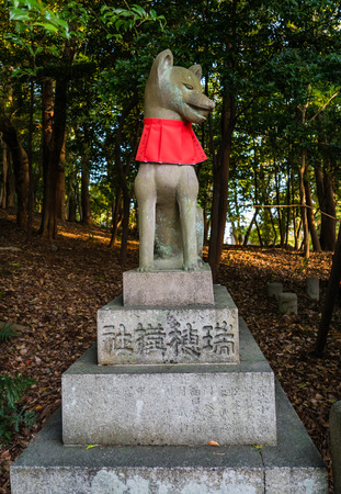 Kyoto, Japan - May 4, 2016: Fox sculpture in Fushimi Inari-taisha shrine. Fushimi Inari Taisha is the head shrine of Inari, located in Fushimi-ku, Kyoto, Japan.のeditorial素材
