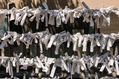 Omikuji - paper strips with random fortunes at small shrine in Kanazawa, Ishikawa Prefecture, Japan.のeditorial素材