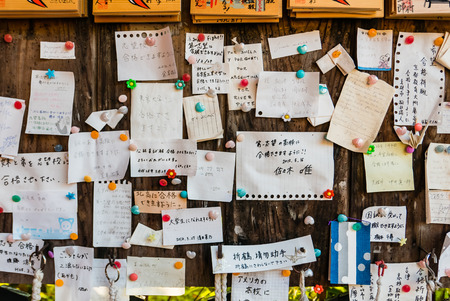 Kyoto, Japan - May 4, 2016: Wishing notes on wooden board at Fushimi Inari Shrine. Fushimi Inari Taisha is the head shrine of Inari, located in Fushimi-ku, Kyoto, Japan.のeditorial素材