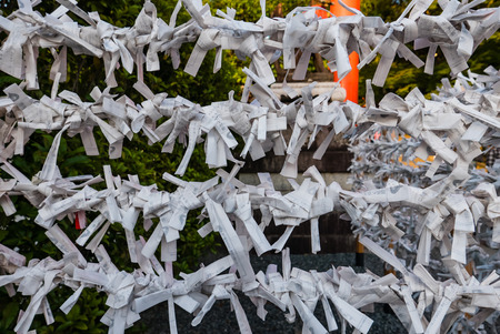 Omikuji - paper strips with random fortunes at Fushimi Inari shrine. Fushimi Inari Taisha is the head shrine of Inari, located in Fushimi-ku, Kyoto, Japan.のeditorial素材