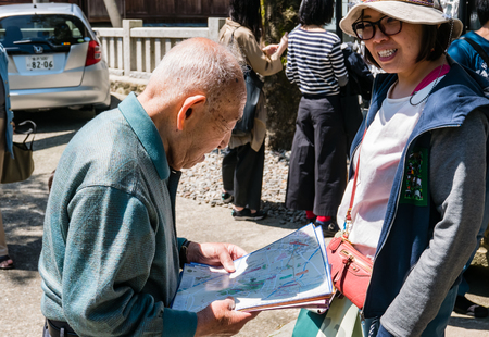Kanazawa, Japan - May 4, 2016: Old Japanese man working as tourist information at Shrine in Kanazawa, Ishikawa Prefecture, Japan.のeditorial素材