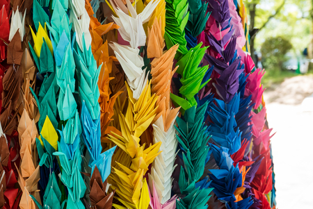 Hiroshima, Japan - May 5, 2016: Brightly coloured origami paper cranes at The Memorial Tower to the Mobilized Students. The Memorial Tower to the Mobilized Students is part of the Hiroshima Peace Memorial in Hiroshima, Japan.のeditorial素材