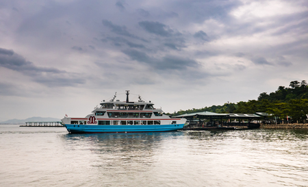 Hiroshima, Japan - May 6, 2016: Matsudai Kisen ferry crossing the inland sea between Miyajimaguchi and Miyajima island. The Ferries carry visitors to the Itsukushima Shrine on island.のeditorial素材