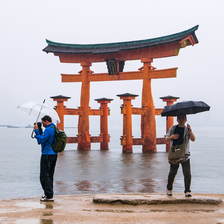 Miyajima, Japan - May 6, 2016: Tourist visit town of Itsukushima floating Torii Gate in Miyajima. Miyajima island is a famous island shrine-town is a UNESCO World Heritage Site and a major tourism destination.のeditorial素材
