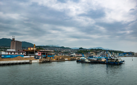 Hiroshima, Japan - May 6, 2016: Cityscape of Miyajimaguchi near Matsudai Kisen ferries (JR ferry-port) crossing the inland sea between Miyajimaguchi and Miyajima.のeditorial素材