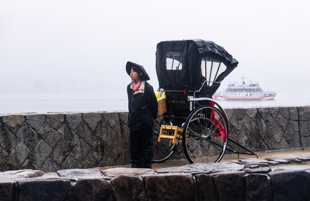 Miyajima, Japan - May 6, 2016: The Rikusha (rickshaw) on Miyajima Island.  Miyajima island is a famous island shrine-town is a UNESCO World Heritage Site and a major tourism destination.のeditorial素材