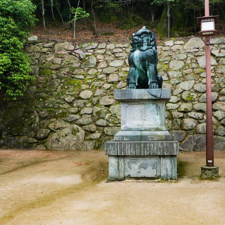 Miyajima, Japan - May 6, 2016: Lion statue on Miyajima island. Miyajima island is a famous island shrine-town is a UNESCO World Heritage Site and a major tourism destination.のeditorial素材