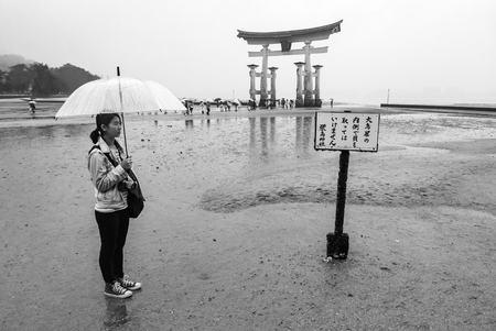 Miyajima, Japan - May 6, 2016: Tourist visit town of Itsukushima floating Torii Gate in Miyajima. Miyajima island is a famous island shrine-town is a UNESCO World Heritage Site and a major tourism destination.のeditorial素材