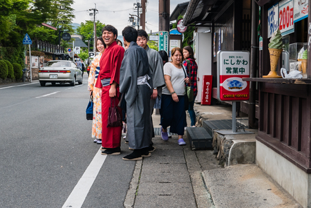 Kyoto, Japan - May 7, 2016: Group of friends dressed kimono shopping near Togetsukyo Bridge in Arashiyama district, Kyoto, Japan. Arashiyama is a district on the western outskirts of Kyotoのeditorial素材