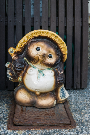 Kyoto, Japan - May 8, 2016: Japanese Raccoon Dog statue  next to street in kyoto, Japan.のeditorial素材