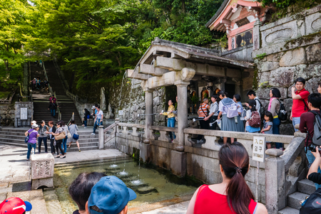 Kyoto, Japan - May 8, 2016: Tourist visiting Otowa-no-taki, the waterfall where visitors drink for health, longevity, and success in studies at Kiyomizu-dera Temple in Kyoto, Japan in the morning.のeditorial素材