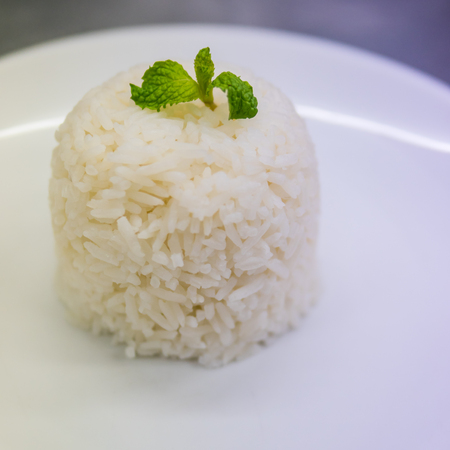 Steamed rice on white plateの写真素材