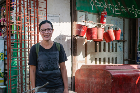 Bagan , Myanmar - October 21, 2016: Smiling tourist at Mani Sithu Market in Nyaung-U village, Bagan, Myanmar (Burma)のeditorial素材