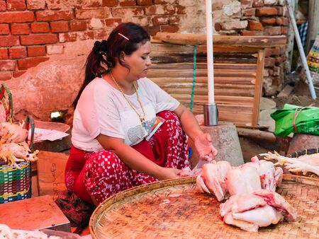 Bagan , Myanmar - October 21, 2016: Burmese woman selling fresh chicken at Mani Sithu Market in Nyaung-U village, Bagan, Myanmar (Burma)のeditorial素材