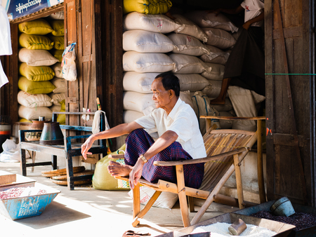 Bagan , Myanmar - October 21, 2016: Burmese man at Mani Sithu Market in Nyaung-U village, Bagan, Myanmar (Burma)のeditorial素材
