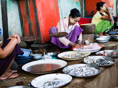 Bagan , Myanmar - October 21, 2016: Burmese woman selling fresh fish at Mani Sithu Market in Nyaung-U village, Bagan, Myanmar (Burma)のeditorial素材