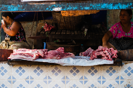 Bagan , Myanmar - October 21, 2016: Burmese woman selling fresh meat at Mani Sithu Market in Nyaung-U village, Bagan, Myanmar (Burma)のeditorial素材
