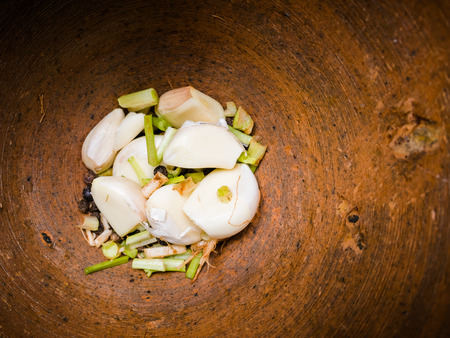 Herbs for Thai cuisine,  garlic, pepper and coriander in mortar.の写真素材