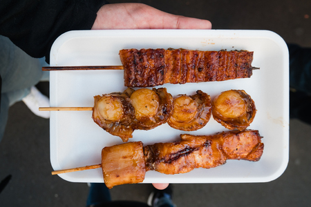 Grilled shell and eel at Tsukiji Fish Market in Tokyo, Japan. It is the biggest wholesale fish and seafood market in the world.の写真素材