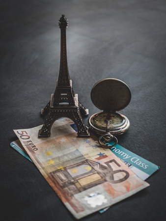 Travel concept - Eiffel tower with 50 euro banknote and boarding passの写真素材