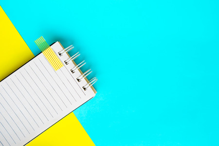 Notebook on Blue and yellow paper background