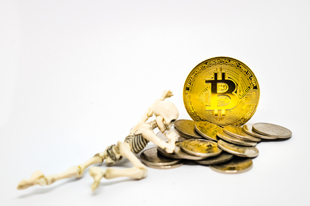 Skeleton figure with golden bitcoin crypto currency.の写真素材