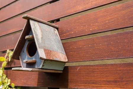 cute little birdhouses on wooden fenceの写真素材