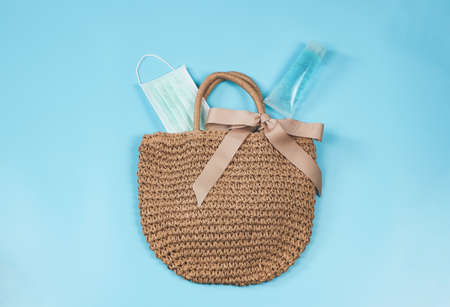 COVID-19 prevention , travel and new normal concept, top view of   woven bag with  sanitizer gel ...