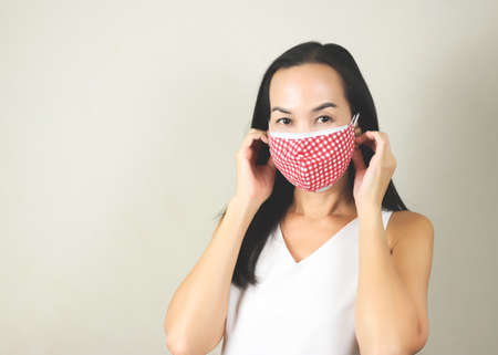 Portrait of Asian woman wearing  double or two face mask to protect from virus  outbreak - concept of safety, healthcare, medical and hygiene.の写真素材