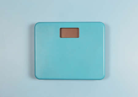 Top view of blue weight scale on blue background.