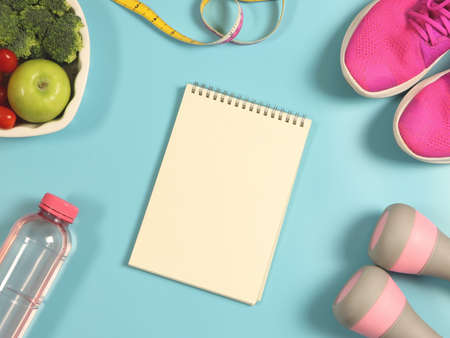 Top view or flat lay of open notebook, vegetables and fruit in heart shape plate, bottle of water, measuring tape,  pink dumbbells and pink sneakers on blue  background. Healthy lifestyle.の写真素材
