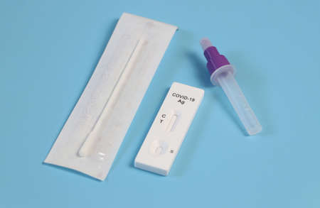 Top view of antigen test kit on blue background.