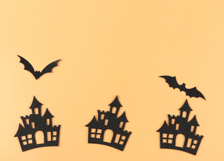 Top view decorations for Halloween holiday, castles and bats on orange background with copy space.の写真素材