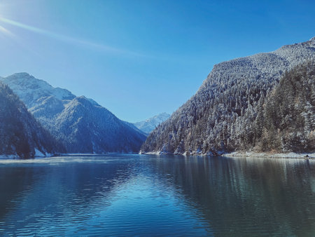 Jiuzhaigou Valley National Park,  Lake in Jiuzhaigou with blue sky, trees and mountain with snow.の写真素材