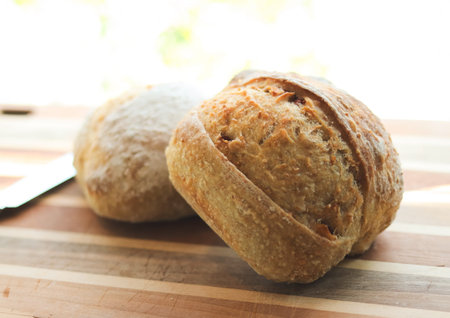 Close up image of  sourdough bread  â€‹â€‹on a rustic wooden cutting board.