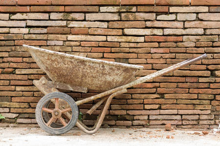Old Construction cart on brick wall background