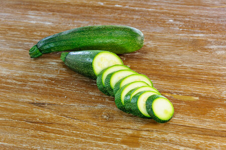 sliced zuccini on wooden backgroundの写真素材