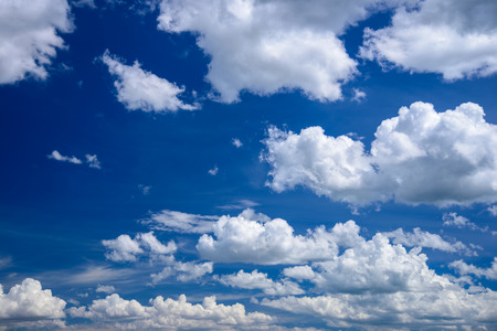 Bright clear blue sky with white clouds.