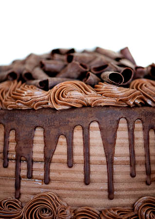 Close-up of Chocolate Cake Topped with Chocoloate Curls and Drizzled with Fudge Icingの写真素材