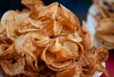 Closeup of hot deep fried potato chips from the festivalの写真素材