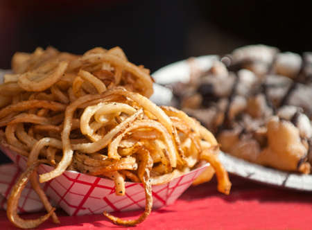 Golden Brown French Fries from the carnival midway with Fry Bread in the background.の写真素材