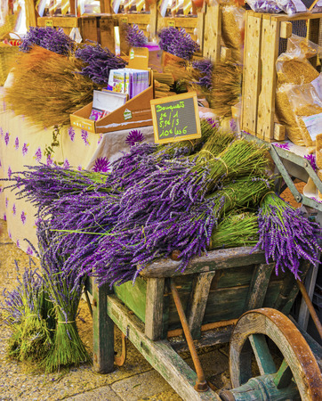 Old Wooden Cart full of fresh Lavender blooms are sold at an outdoor market in the town of Saulte, Franceの写真素材