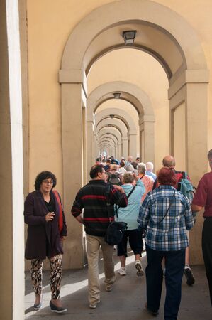 Florence, Italy-October 22, 2013:  Series of Arched doorways in Florence, Italy in which tourists walk to view the city.のeditorial素材